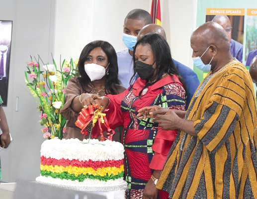 Alhaji Asei Mahama Seini (right)   together with Dr Mrs Charity Sarpong (middle) and Mrs Felicia Dapaah, Chief   Director, RCC, cutting the cake to commemorate the day