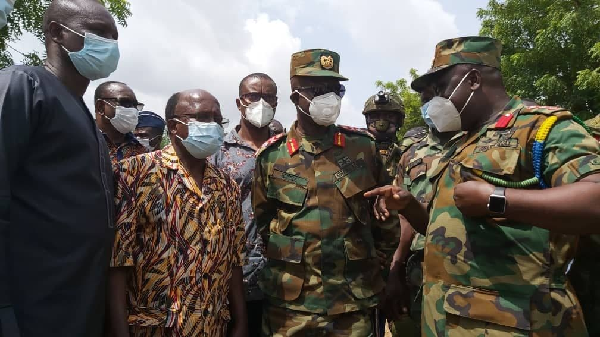  Major General Emmanuel Kotia (2nd right), the National Coordinator, Ghana Boundary Commission, and Mr Douti Lardja (2nd left), Secretary to the Togo Lands Commission, being briefed on the border dispute