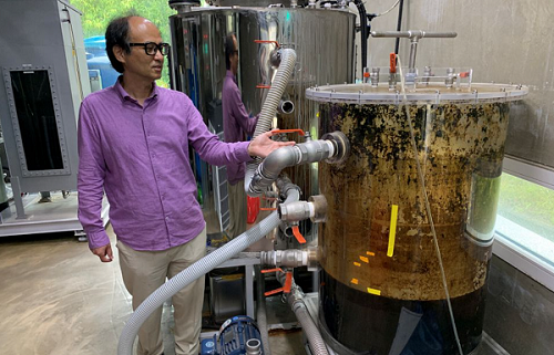 Cho Jae-weon, a South Korean professor at Ulsan National Institute of Science and Technology (UNIST), stands next to a faeces tank at a laboratory