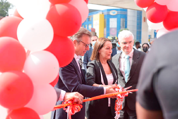 • Ms Anne Sophie Ave (middle), the French Ambassador to Ghana, being assisted by Mr Eric Fanchini, MD, Total Ghana (left) and Mr Paulo Fernandes, GM, CFAO Ghana, cutting the tape to open the first Autofast Centre at Total Station along the Liberation Road
