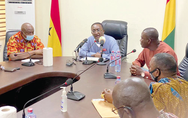 Dr Owusu Afriyie Akoto (middle), Minister of Food and Agriculture, addressing the meeting while Mr Mohammed Hardi (left), a Deputy Minister of Agric, and Mr Richard Collins Arku (right), the DCE of North Tongu, look on