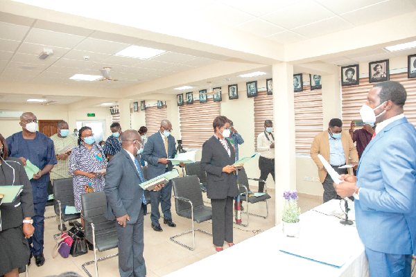 • Dr Yaw Osei Adutwum (right), Minister of Education  swearing in members of the Governing Council