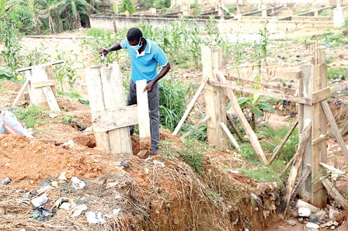 The mason pulling down the pillars as instructed  by the regional minister. Pictures: EMMANUEL BAAH