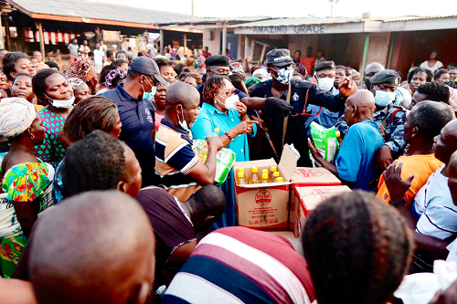 •Madam Mavis Hawa Koomson (arrowed) addressing the fishermen at a fishing community during the distribution of the relief items