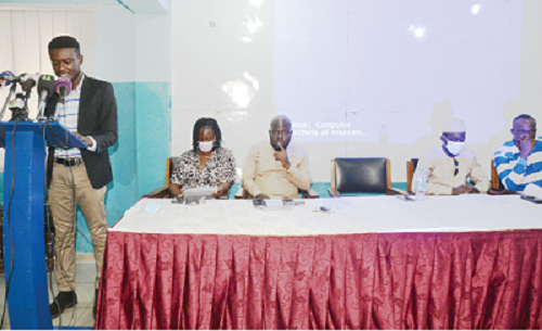 • Mr Felix Asirifi (standing), Acting Executive Director of Data and Advocacy Consult, speaking at the press briefing. 