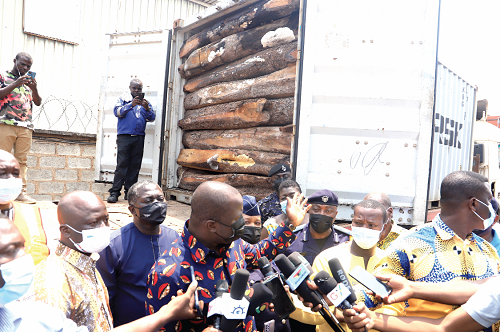 Mr Samuel Abu Jinapor (hand raised), Minister of Lands and Natural Resources, explaining a point to the media after inspecting the confiscated Rosewood at the Global Container Terminal at the Tema Port. Picture: Samuel Tei Adano