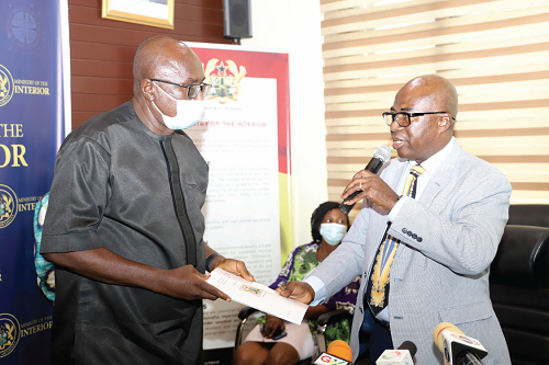 Justice George Kingsley Koomson (right), Chairman of the Committee on the Ejura incident,  presenting the report to Mr Ambrose Dery (left), Minister for the Interior, at a meeting in Accra. Picture: GABRIEL AHIABOR