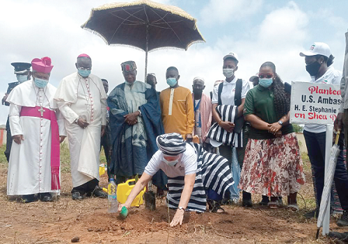 Ms Stephanie Sullivan, US Ambassador to Ghana, planting a shea seedling. Those with her from left are Most Rev. Peter Paul Y. Angkyier, Catholic Bishop of Damongo; Most Rev. Philip Naameh, Archbishop of the Catholic Archdiocese of Tamale;  Buipewura Jinapor ll, Mr Yaw Adu Asamoah, Savannah Regional Coordinating Director, and Ms Rosslyn Fosuah Adjei from the Forestry Commission