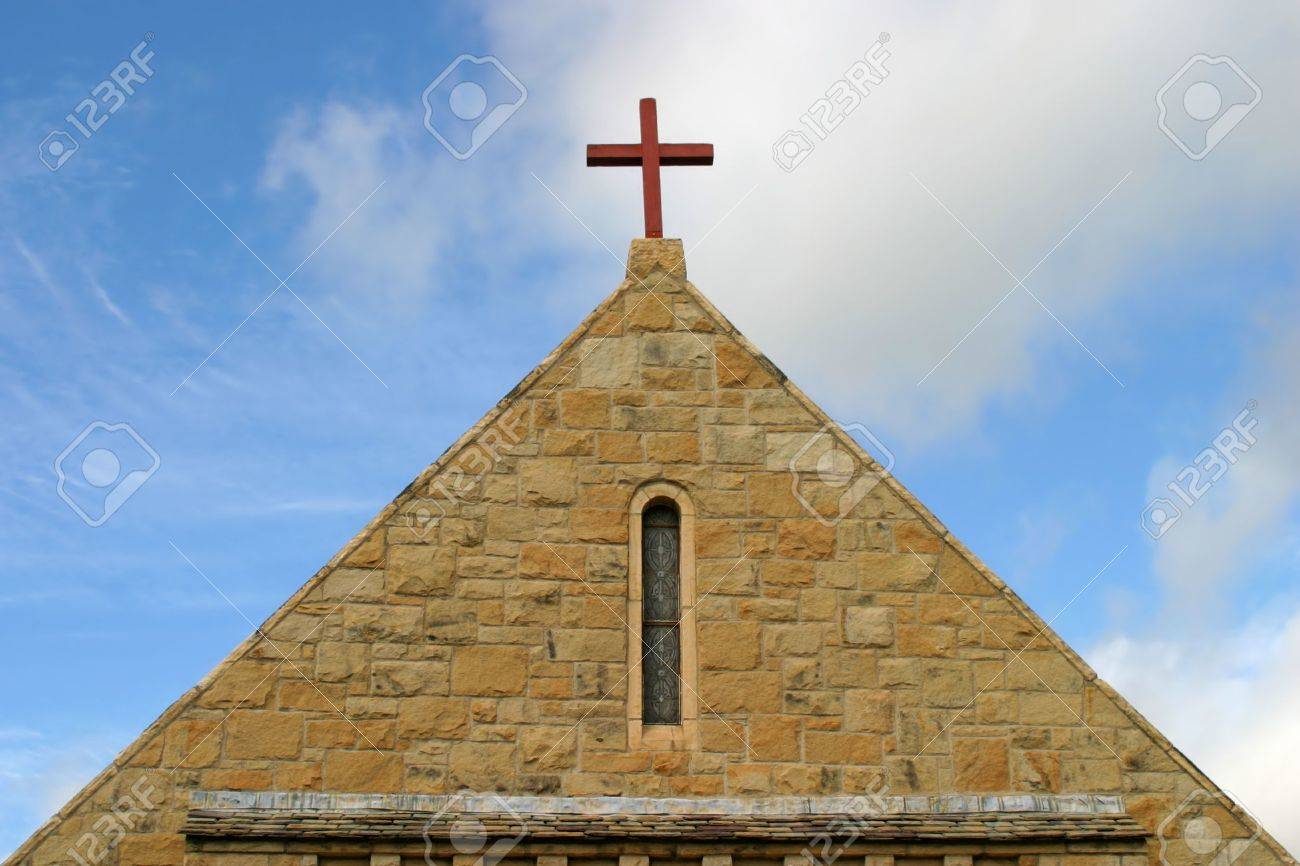 The view of a church roof with a cross on top