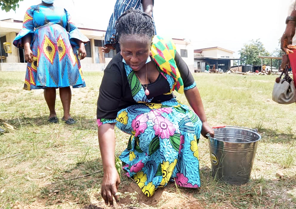 Ms Comfort Attah, MCE, planting one of the trees