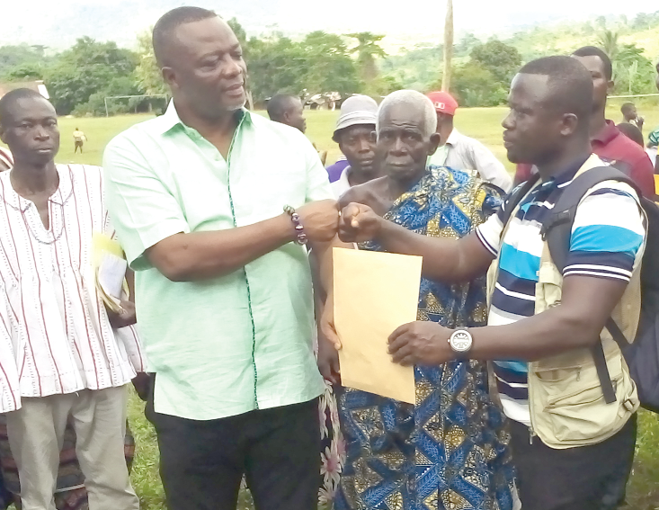  Mr Albert Tetteh Nyakotey (left), MP for Yilo Krobo,  handing over the building plan and other documents to Mr Robert Dotse, the contractor, at the site    