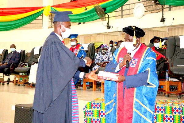 • Rev. Dr Charles Fosu-Ayarkwah (right), Principal of the KPCE, presenting an award to one of the graduands