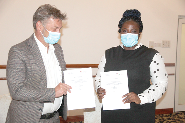 Mr Gerald Guskowski (left), Head of Network for Inclusive Economic Development (NIED), and Dr Augustina Odame,  Chief Executive Officer of the Ghana Chamber of Technology, displaying copies of the agreement. Picture: ESTHER ADJEI
