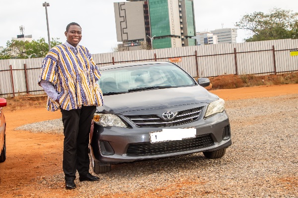 Dr Addipa-Adapoe standing by his car