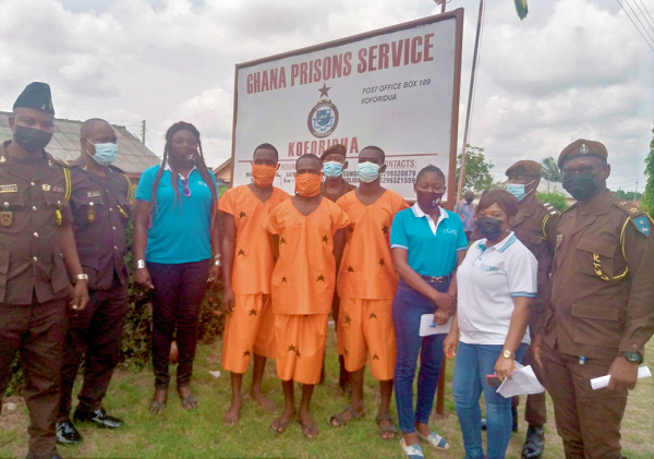 The freed convicts (middle) with officials from CHIR and Prisons officers at the Koforidua Prisons