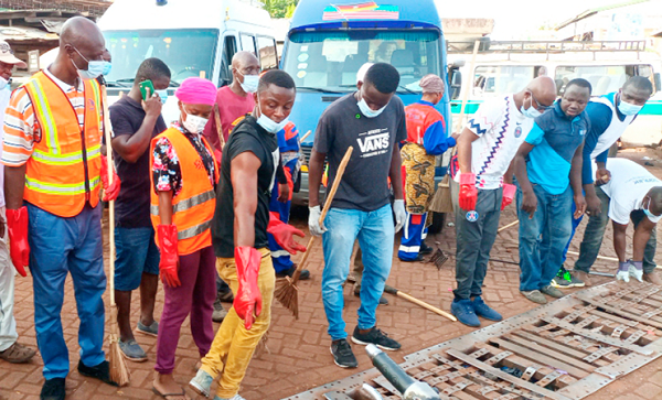 • Alhaji Shani Alhassan Shaibu (left), the Northern Regional Minister together with some residents during the clean- up exercise