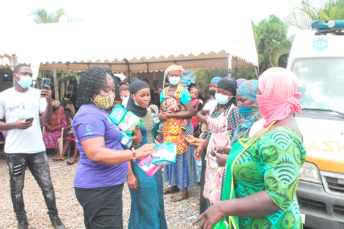 Dr Mary Amoakoh-Coleman, President of Medical Women's Association, Ghana (MWAG), distributing sanitary pads to "kayaye" at Madina Polyclinic, Kekele, in commemorate Menstrual Hygiene Day. Picture: Maxwell Ocloo