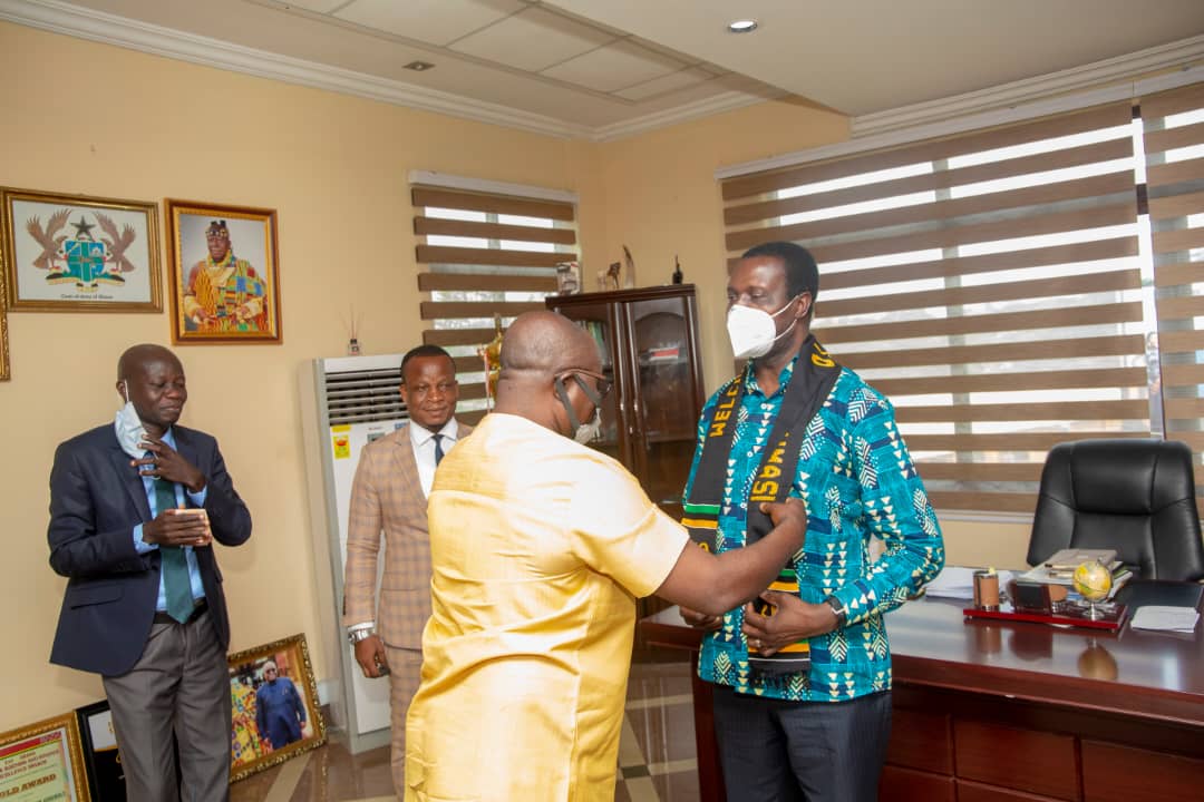 Dr Yaw Osei Adutwum (right), the Minister of Education, being decorated with a stole of Kente by Mr Osei Assibey Antwi, the Chief executive of the KMA
