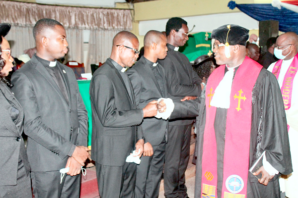 • Rt Rev. Lt Col Bliss Divine Kofi Agbeko (retd) (right), Moderator of the General Assembly, Evangelical Presbyterian Church, Ghana, exchanging pleasantries with the newly commissioned ministers. 