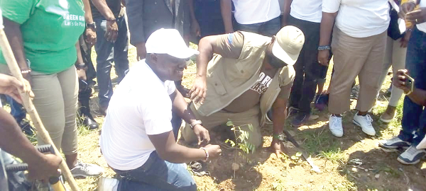 • Mr Michael Okyere Kofi Baafi (right), the NPP Member of Parliament for New Juaben South,  assisted by Mr Poku Bosompem (left), Deputy Eastern Regional Director of the Forestry Commission, to plant one of the trees at Nkubemu in Koforidua