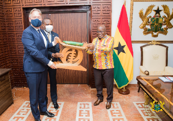   President Akufo-Addo presenting a gift to Mr Christoph Retzlaff (left), outgoing German Ambassador to Ghana, at the Jubilee House