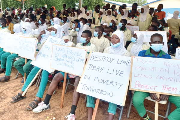 Schoolchildren displaying placards to commemorate this year’s World Day to Combat Desertification and drought at Sambu in the Northern Region