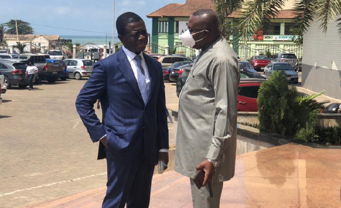 Dr Stephen Kwabena Opuni (left) talking to Mr Samuel Ofosu Ampofo , the National Chairman of the National Democratic Congress (NDC) after the hearing
