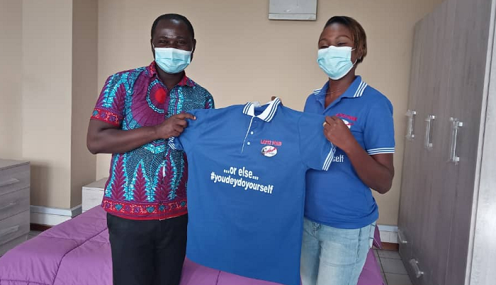 The Public Relations Officer of Latex Foam, Gifty E. Appiah presenting the items to the Manager of the Centre of the World Golf Club, Kwadwo Antwi Boateng at the company's head office in Accra. 