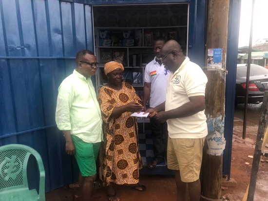 Mr Dadzie (right) presenting the money to Madam Mankosa, standing next to them are other members of the association