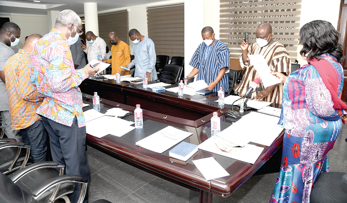 Ms Cecilia Abena Dapaah (right), Minister of Sanitation and Water Resources, swearing in members of the governing board