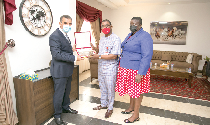 Mr Mohamed Melad (left), Charge d'Affaires, Libya Embassy in Accra, presenting a gift to Mr Kobby Asmah, Editor, Daily Graphic. With them is Ms Mary Mensah, Foreign News Editor