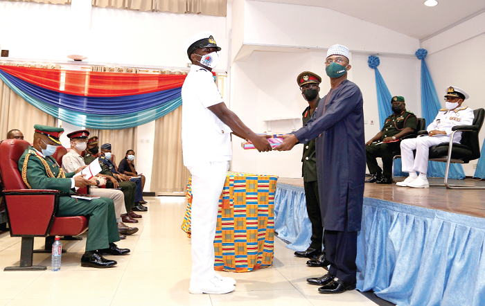 Air Vice Marshall Issifu Sakib Kadri (retd) [standing right], a former Commandant of the GAFCSC, presenting the Overall Best Student Award to Lt Cdr Edem Akati of the Ghana Navy as Rear Admiral Moses Beick Baffour (seated right), Commandant, GAFCSC, and other dignitaries look on. Picture: NII MARTEY M. BOTCHWAY