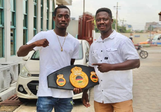 Coach Lawrence Carl Lokko (right) with his boxer John Laryea