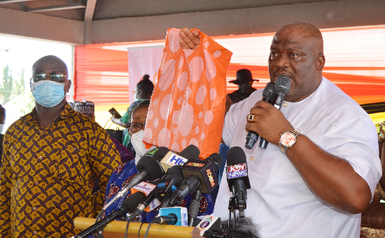  Mr. Henry Quartey (right), Greater Accra Regional Minister, holding a cash in designer polythene bag ready to present. Picture: ESTHER ADJEI 