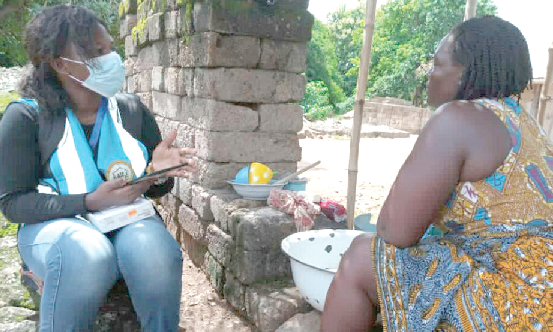  An enumerator interacting with a resident in Ho 