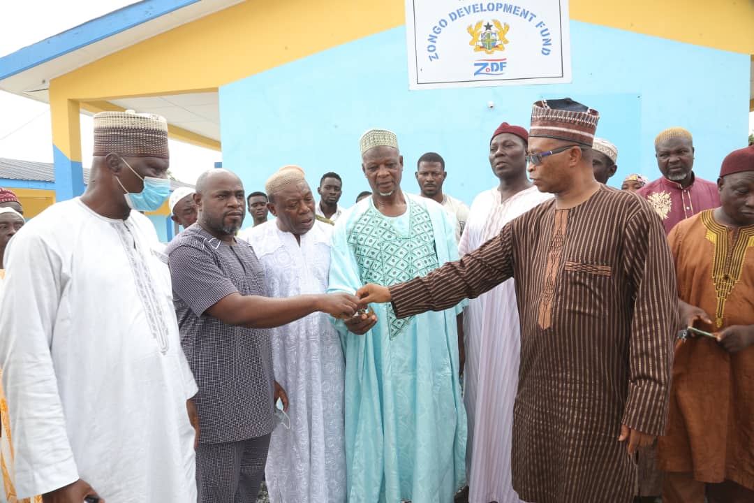 Dr Arafat Sulemana Abdulai (r) handing over keys to a six-unit fully furnished school block to Mr Seth Birimkorang, DCE for Denkyeambour. Looking on are chiefs and Imams of Boadua. Insert is the pictures of the school block.