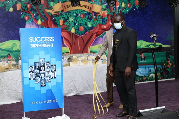 A dummy of the book being unveiled