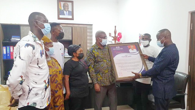 The delegation of the Western North Grassroots Agenda (WENGA) of the New Patriotic Party (NPP), presenting the plaque with the citation to Mr. Peter Mac Manu, the 2020 Campaign Manager for the party,  at the party's campaign office in Accra.