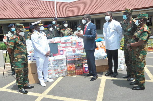 Mr Ernest Domie, Group Chairman of OBZ Ghana Ltd (4th right), explaining a point to Admiral  Seth Amoama, CDS (2nd left), after the presentation of the items. With them is Dr Okoe Boye (3rd right), former deputy Health Minister