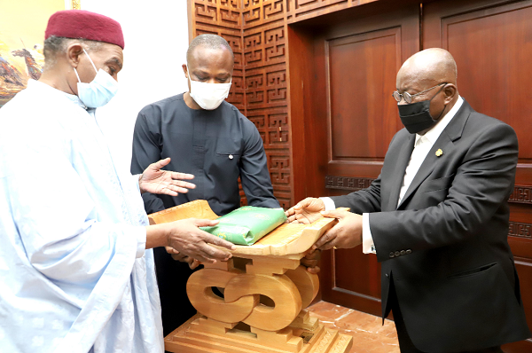 President Nana Addo Dankwa Akufo-Addo presenting a parting gift to Dr Alhasseini Ousumane (left), Out-going Nigerien Ambassador to Ghana at the Jubilee House. Picture: SAMUEL TEI ADANO