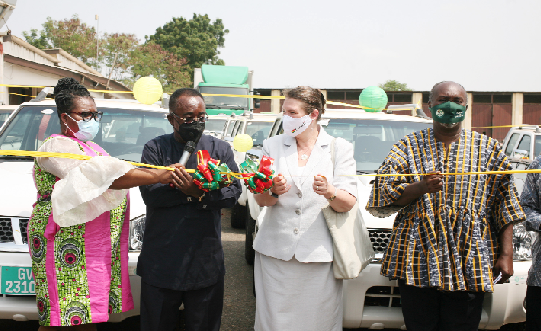 Dr. Owusu Afriyie Akoto (2nd left), Minister of Food and Agriculture, being supported by Ms. Kati Csaba (2nd right), Canadian High Commissioner to Ghana, to perform the symbolic commissioning of the vehicles (below). With them are Ms. Ruby Mills-Palme (left), Coordinator, Modernising Agriculture in Ghana programme, and Mr. Robert Patrick Ankobiah, acting Chief Director, Ministry of Food and Agriculture. Picture: Maxwell Ocloo
