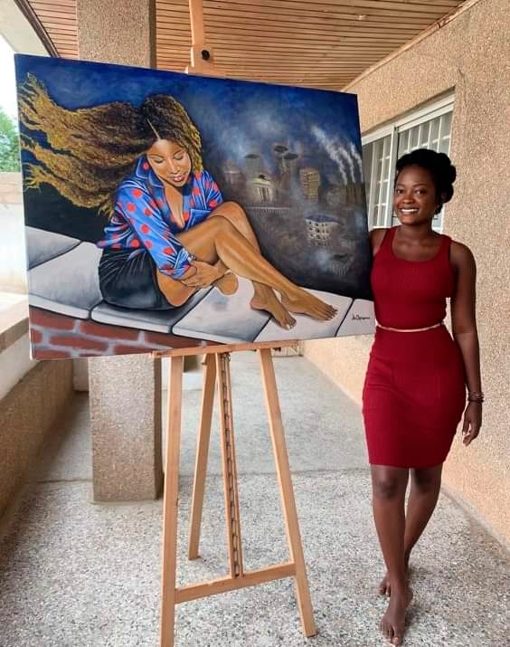 Abena Oyiwaa Art (right) posing by one of her artworks  titled Peace Within