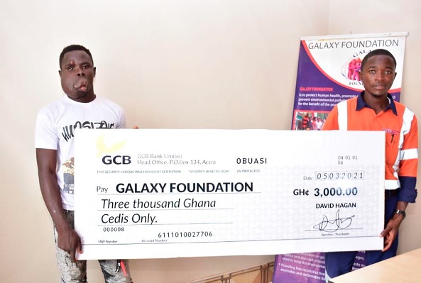 Mr Hagan (right), presenting the dummy cheque to Yakubu Kantab