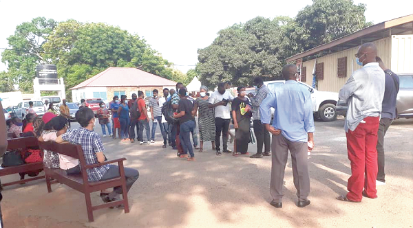 A health worker at the Adabraka Polyclinic taking down the names of some of the people while others wait for the vaccination on benches. Picture: EDMUND SMITH-ASANTE