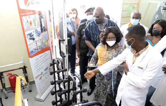  Mr. Emmanuel Adu (right), physiotherapist at the Medical Rehab Centre, Jubilee House, explaining the functions of a machine to Mrs. Akosua Frema Osei-Opare (2nd right), Chief of Staff