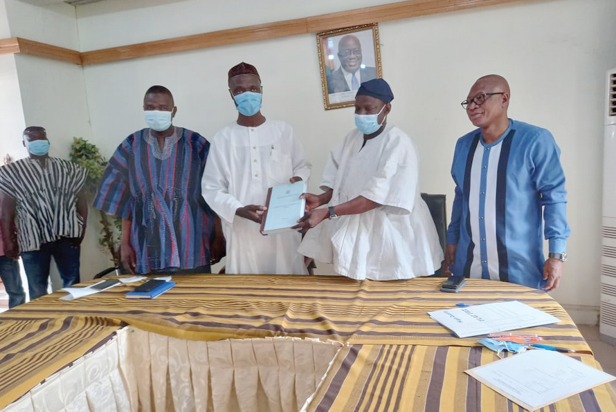 Mr Salifu Saeed (2nd left), the outgoing Northern Regional Minister, presenting his handover notes to Mr Shani Alhassan Shaibu (2nd right), his successor. With them are Mr Alhassan Issahaku (right), Northern Regional Co-ordinating Director and Mr Mohammed Samba (left), Northern Regional Chairman of the NPP