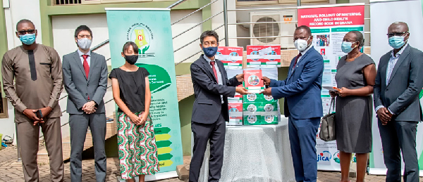 Mr. Araki Yasumichi (4th left), the Chief Representative of JICA Ghana, presenting the books to the Dr. Patrick Kuma-Aboagye, Director-General, GHS