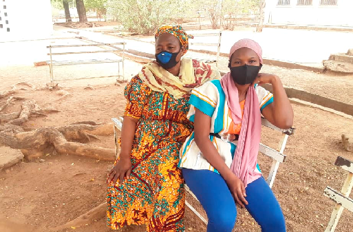 Hajia Alhassan Habiba (behind) and her daughter, Miss Mamata Alhassan sitting on one of the visitors' benches at the Bolgatanga Girls Senior High School