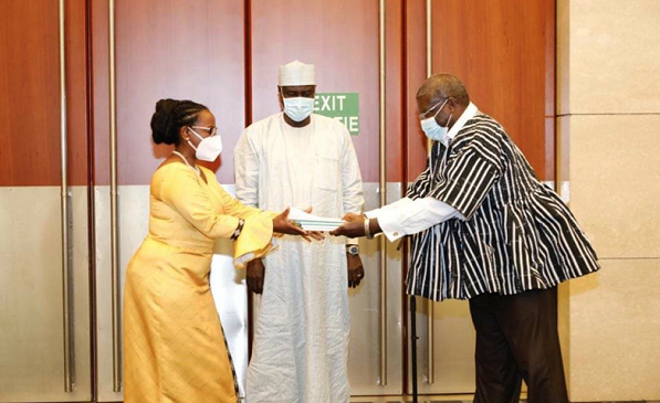 Mr Quartey (right) presenting handover notes to Dr Monique Nsanzabaganwa, his successor