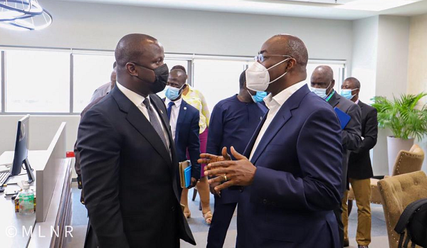The Minister for Lands and Natural Resources, Samuel A. Jinapor (left) interacting with the CEO of GIADEC, Mr. Michael Ansah during the Minister's visit to GIADEC head office in Accra.